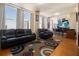 Comfortable living room with large windows and hardwood floors at 57 Forsyth Nw St # 16D, Atlanta, GA 30303
