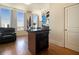 Living room with a view of the kitchen including a built-in island and bar seating at 57 Forsyth Nw St # 16D, Atlanta, GA 30303