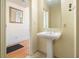Bathroom featuring a pedestal sink, tile floor and decorative mirror. Doorway to hallway at 57 Forsyth Nw St # 16D, Atlanta, GA 30303