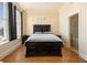 Bedroom with hardwood floors and large windows with black curtains at 57 Forsyth Nw St # 16D, Atlanta, GA 30303