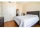 Bedroom with hardwood floors, closet doors, and a doorway to the kitchen at 57 Forsyth Nw St # 16D, Atlanta, GA 30303