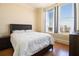 Bedroom featuring large windows, hard wood floors, and a side table at 57 Forsyth Nw St # 16D, Atlanta, GA 30303