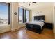 Bedroom with hardwood floors, large windows, and city view at 57 Forsyth Nw St # 16D, Atlanta, GA 30303