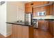Kitchen with stainless steel appliances, granite countertops, island cooktop and wood cabinets at 57 Forsyth Nw St # 16D, Atlanta, GA 30303