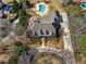 A bird's eye view of an estate with a kidney-shaped pool, complemented by lush greenery and a well-maintained landscape at 8531 N Shore Dr, Jonesboro, GA 30236