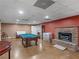 Finished basement with a pool table and fireplace at 8531 N Shore Dr, Jonesboro, GA 30236