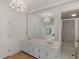 Bathroom featuring white cabinets, mirror and a shower at 8531 N Shore Dr, Jonesboro, GA 30236