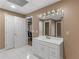 Bright bathroom featuring tiled floor, vanity with storage, and doors leading to other rooms at 8531 N Shore Dr, Jonesboro, GA 30236