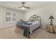 Standard bedroom featuring a ceiling fan, double hung windows, and carpet floors at 8531 N Shore Dr, Jonesboro, GA 30236