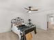 Bright bedroom with ceiling fan, white walls and decorative metal frame bed at 8531 N Shore Dr, Jonesboro, GA 30236