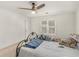 Bright bedroom with ceiling fan, white walls and metal frame bed near window at 8531 N Shore Dr, Jonesboro, GA 30236