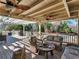Inviting covered patio area featuring ceiling fans and comfortable wicker furniture overlooking the backyard and pool at 8531 N Shore Dr, Jonesboro, GA 30236