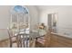 Bright dining room featuring a round glass table, comfortable seating for six, and a large window for natural light at 8531 N Shore Dr, Jonesboro, GA 30236