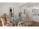 Charming dining room with a glass table and seating for six, accented by stylish mirrors and wood accents at 8531 N Shore Dr, Jonesboro, GA 30236