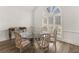 Well-lit dining room with a glass table set, complemented by charming chairs and a unique arched window at 8531 N Shore Dr, Jonesboro, GA 30236