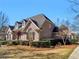 Beautiful home with a brick facade, well-maintained landscaping, and elegant architectural details under a bright blue sky at 8531 N Shore Dr, Jonesboro, GA 30236