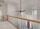Bright hallway featuring wooden railings and light filled landing at 8531 N Shore Dr, Jonesboro, GA 30236