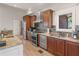 Modern kitchen features stainless steel appliances, granite countertops, and wood cabinets with custom tile backsplash at 8531 N Shore Dr, Jonesboro, GA 30236