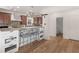 Modern kitchen with stainless steel appliances, wooden cabinets, and a breakfast bar area with seating for casual dining at 8531 N Shore Dr, Jonesboro, GA 30236