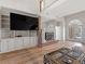 Inviting living room with a brick fireplace, built-in shelves, and large windows creating a bright, open space at 8531 N Shore Dr, Jonesboro, GA 30236
