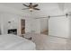 Main bedroom featuring a fireplace, tray ceilings, carpet floors, and an en-suite bathroom and secondary closet at 8531 N Shore Dr, Jonesboro, GA 30236