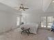 A spacious and sunlit main bedroom with tray ceilings, a ceiling fan, and patio door access at 8531 N Shore Dr, Jonesboro, GA 30236