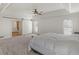 Spacious main bedroom with tray ceilings, carpet floors, and an en-suite bathroom behind a sliding barn door at 8531 N Shore Dr, Jonesboro, GA 30236