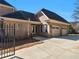 Brick home featuring an attached garage and a spacious driveway with ample parking at 8531 N Shore Dr, Jonesboro, GA 30236
