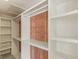 Walk-in closet with custom wooden accents and shelving at 8531 N Shore Dr, Jonesboro, GA 30236
