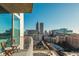 Condo balcony view of the Atlanta skyline with seating for two at 860 Peachtree St # 1418, Atlanta, GA 30308
