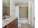 Bathroom featuring granite counters, wood vanity, and shower-tub combination at 860 Peachtree St # 1418, Atlanta, GA 30308