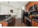 Spacious kitchen with stainless steel appliances, modern cabinetry, black subway tile backsplash, and granite countertops at 860 Peachtree St # 1418, Atlanta, GA 30308