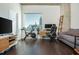 Inviting living space featuring dark hardwood floors, home gym equipment, and plenty of natural light and modern furnishings at 860 Peachtree St # 1418, Atlanta, GA 30308