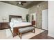 Relaxing main bedroom featuring hardwood floors, concrete accent wall, and a decorative rug at 860 Peachtree St # 1418, Atlanta, GA 30308