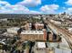Expansive aerial view of complex with brick buildings, lush green spaces, and city skyline in the background at 170 Boulevard Se # H428, Atlanta, GA 30312