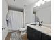Contemporary bathroom with a dark vanity, marble countertop, and a combination tub and shower at 170 Boulevard Se # H428, Atlanta, GA 30312