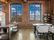 Dining area features exposed brick, large windows, and modern table setting at 170 Boulevard Se # H428, Atlanta, GA 30312