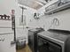Organized laundry room with side-by-side washer and dryer and storage shelving for convenience at 170 Boulevard Se # H428, Atlanta, GA 30312