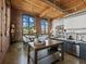 Bright living area featuring exposed brick, wood ceilings, large windows, and modern kitchen at 170 Boulevard Se # H428, Atlanta, GA 30312