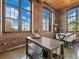 Living area with exposed brick walls, wood ceilings, and large windows providing ample natural light at 170 Boulevard Se # H428, Atlanta, GA 30312