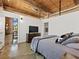 Well-lit bedroom with exposed brick, a large TV, and modern minimalist decor at 170 Boulevard Se # H428, Atlanta, GA 30312