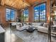 Living room boasts exposed brick walls, large windows, and stylish decor with natural light at 170 Boulevard Se # H428, Atlanta, GA 30312