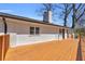 A large wood deck wraps around the home's exterior with white painted brick at 2917 Mcafee Rd, Decatur, GA 30032