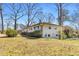 Exterior view of a home with bright white brick and large backyard at 2917 Mcafee Rd, Decatur, GA 30032