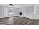 Bright living room featuring a brick fireplace, stylish flooring, and an open layout at 2917 Mcafee Rd, Decatur, GA 30032