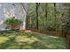 Well maintained backyard with a wooden fence, mature trees, and lush grass at 4184 Westchester Ne Trce, Roswell, GA 30075