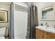 Bathroom features a large shower with subway tile, patterned shower curtain, and a modern vanity at 4184 Westchester Ne Trce, Roswell, GA 30075