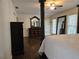 Bedroom showcasing hardwood floors, a four-poster bed, and a large mirror at 4184 Westchester Ne Trce, Roswell, GA 30075