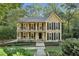 Charming two-story home features a welcoming front porch on both levels and manicured landscaping at 4184 Westchester Ne Trce, Roswell, GA 30075
