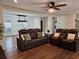 Open-concept living room with hardwood floors, natural light, and a ceiling fan at 4184 Westchester Ne Trce, Roswell, GA 30075